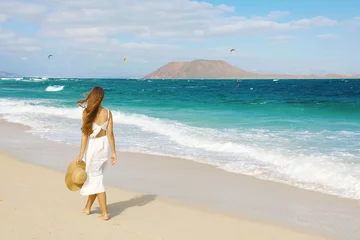 Printed kitchen splashbacks Canary Islands Young woman walking on Corralejo wild beach looking at Lobos Island on the background, Fuerteventura, Canary Islands