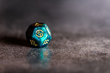 Astrology Dice with zodiac symbol of Cancer Jun 21 - Jul 22 on dark background