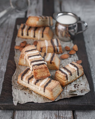 puff pastry with chocolate side view on a dark kitchen board on old textured wooden background closeup