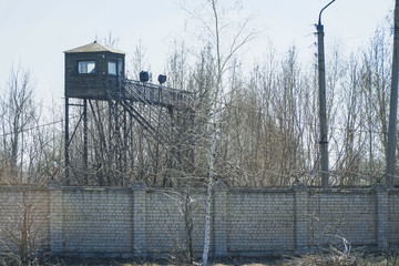 Watchtower at the fence with barbed wire