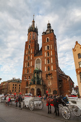 Naklejka na ściany i meble KRAKOW, POLAND - MAY, 11, 2018: Main Market Square with St. Mary's Church. It is the largest medieval town square in Europe.