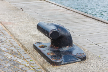 Steel anchoring bollard on the shore