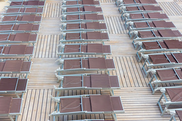 Rrows of brown deck chairs closed on cruise ship