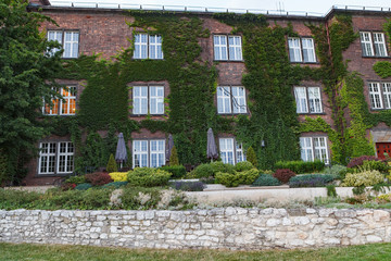 KRAKOW, POLAND - MAY, 11, 2018: The view of Wawel Royal Castle, Exhibition Center covered with greenery