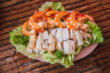 High Angle View Of Seafood And Vegetables In Plate On Table
