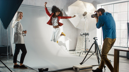 Backstage of the Photo Shoot: Moment Photographer Taking Photos of Jumping Beautiful Black Model...