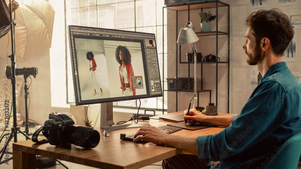 Poster backstage of the photoshoot: photo editor works on desktop computer retouching photos of beautiful b