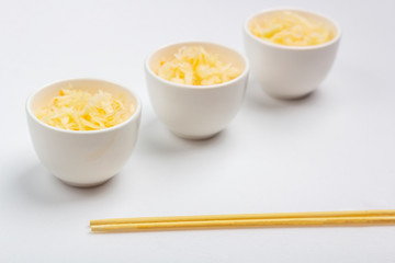 Sauerkraut or fermented cabbage in a bowl on white background. The concept of proper nutrition and healthy eating.  Organic and vegetarian food. Close up, copy space for text