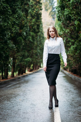 Young business woman walking outdoors in Park
