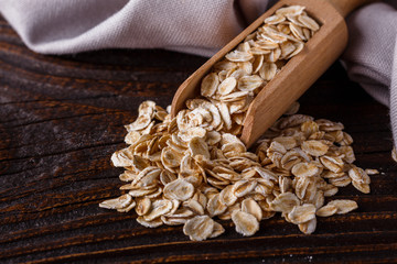 raw oatmeal on a wooden rustic background