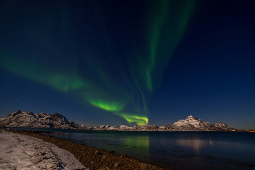 Naklejka na ściany i meble Dramatic polar lights, Aurora borealis over the mountains in the North of Europe - Lofoten islands, Norway