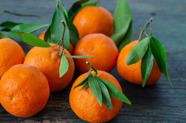 Fresh mandarins and leaf on the wooden table
