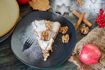 Homemade apple pie and walnuts, top view.