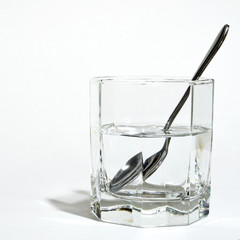 steel spoon in a glass with clear water