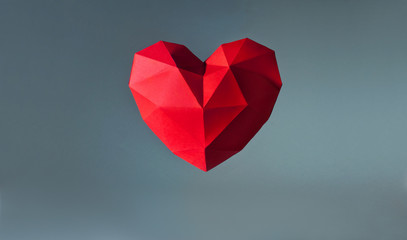 Paper geometric volume heart on grey background