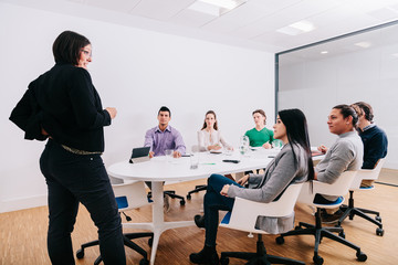 Group of office workers at a meeting around the boss