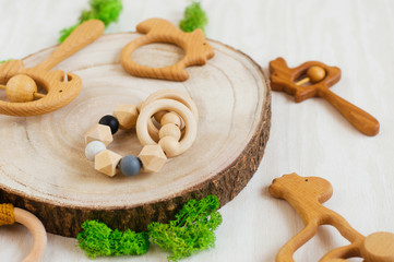 Wooden baby teethers on natural wooden background