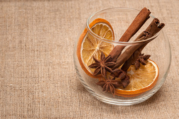 composition from spices: dried orange, anise, cinnamon. on linen cloth background