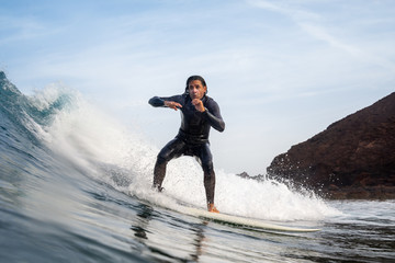 surfer riding waves on the island of fuerteventura