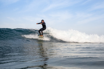 surfer riding waves on the island of fuerteventura