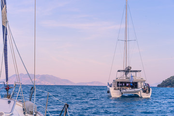 Scenic beautiful sunrise with a view on a boat at the marine of Epidaurus Island, Peloponnese, Saronic Gulf, Greece. 