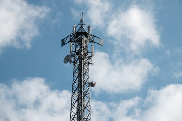 telecommunication antennas in cloudy sky