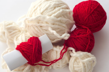Skeins of threads. one of the balls of yarn in the shape of a heart.
