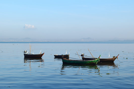 Image of many small boats on the sea with a not so bright atmosphere on a sunny day