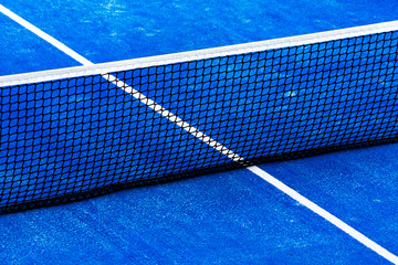 Blue paddle tennis court field with net background