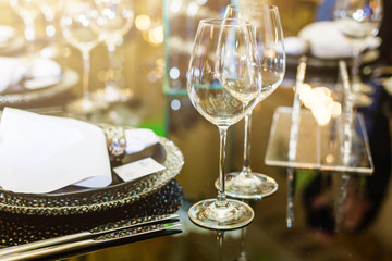 Banqet wedding party in reastaurant. Wine glasses on a table with silver plates