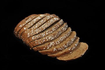 Slices of brown bread at black background
