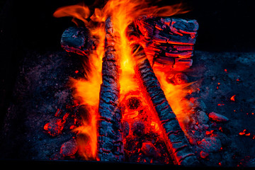 Fiery background. Live coals. Burning firewood.