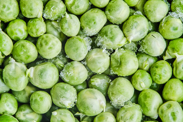 Frozen green peas with pieces of ice. Healthy Food. Macro. Close-up.