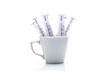 Closeup of a transparent oral syringe for children's medicine, isolated on white background