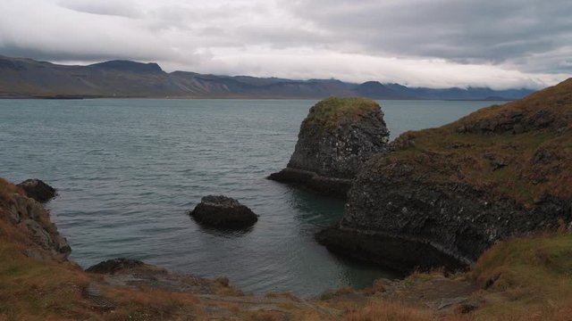 Volcanic basalt formations by a fjord in West Iceland