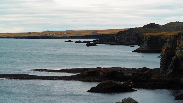 A rocky beach with volcanic basalt formations in West Iceland