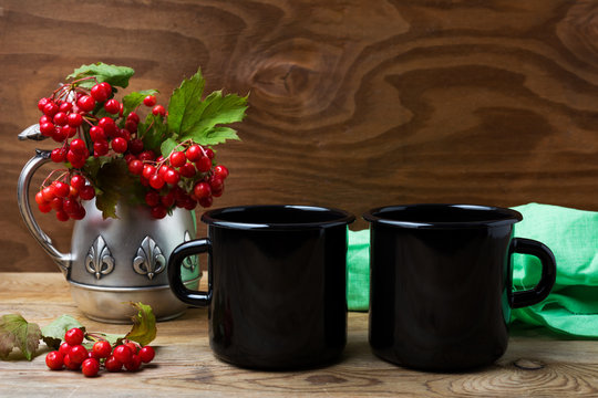Two black campfire enamel mug mockup with cranberry