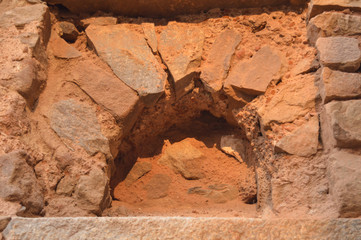 A sun create some dramatic view of fort, monument at hauz khas memorial from the side of the lawn at winter foggy morning.