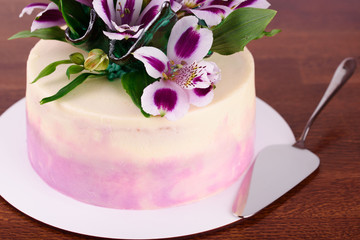 Obraz na płótnie Canvas Delicious beautiful cake is impregnated with tender cream, decorated with flowers.
