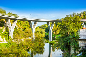 Croatia, Rastoke, road bridge and old water mills on waterfalls of Korana river, beautiful countryside landscape