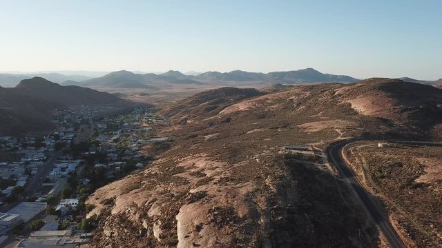 4K high quality sunny morning aerial panorama footage of spectacular scenic Springbok town, set among rocky mountains in Northern Cape province, South Africa near the border with neighbouring Namibia