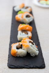 Japanese sushi food served on blackboard plate