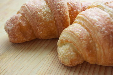 Macro photo of croissants on wooden background