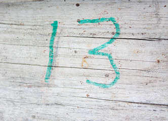 The number 13 is written on old wooden boards.