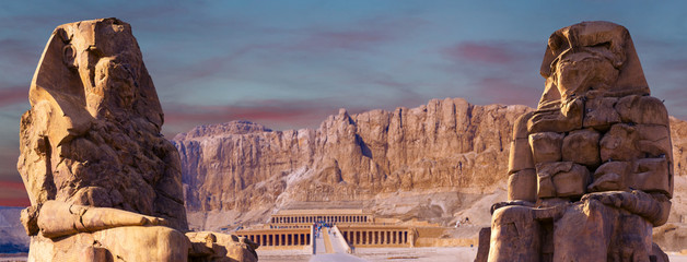 Colossi of Memnon Luxor Thebes against the background of dawn in the Egypt