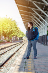 Solo traveller : Asian woman waiting train for journey in train station. Woman backpacking starting traveling on train station background, journey on holiday concept. travel concept