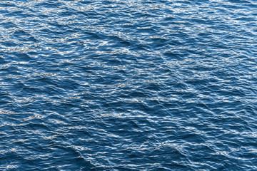 Blue water surface. Background texture photo of a water, river or sea. Clear wawing water surface.