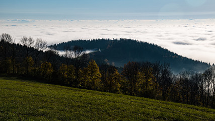 Naklejka na ściany i meble Beautiful autumn or indian summer view above the clouds near Kostenz, Bavarian forest, Bavaria, Germany