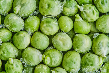 Frozen green peas with pieces of ice. Healthy Food. Close-up. Macro.