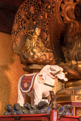 Golden wooden statue depicting the bodhisattva Fugen depicted riding on a white elephant symbol of firmness in the Tendai Buddhism Gokokuin temple in the Ueno district of Tokyo.